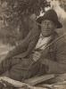 Man wearing a black hat and holding a stick. Circa 1928-34.
