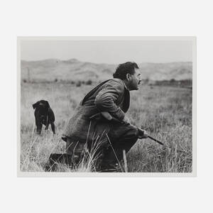 Ernest Hemingway hunting for pheasants with his dog, Sun Valley, Idaho