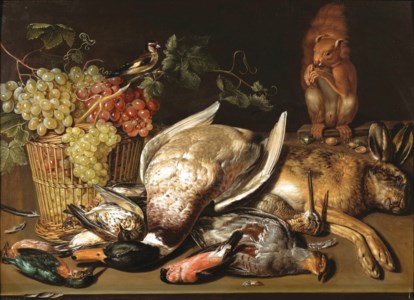 A basket of red and green grapes, a goldfinch, game and a squirrel on a wooden table