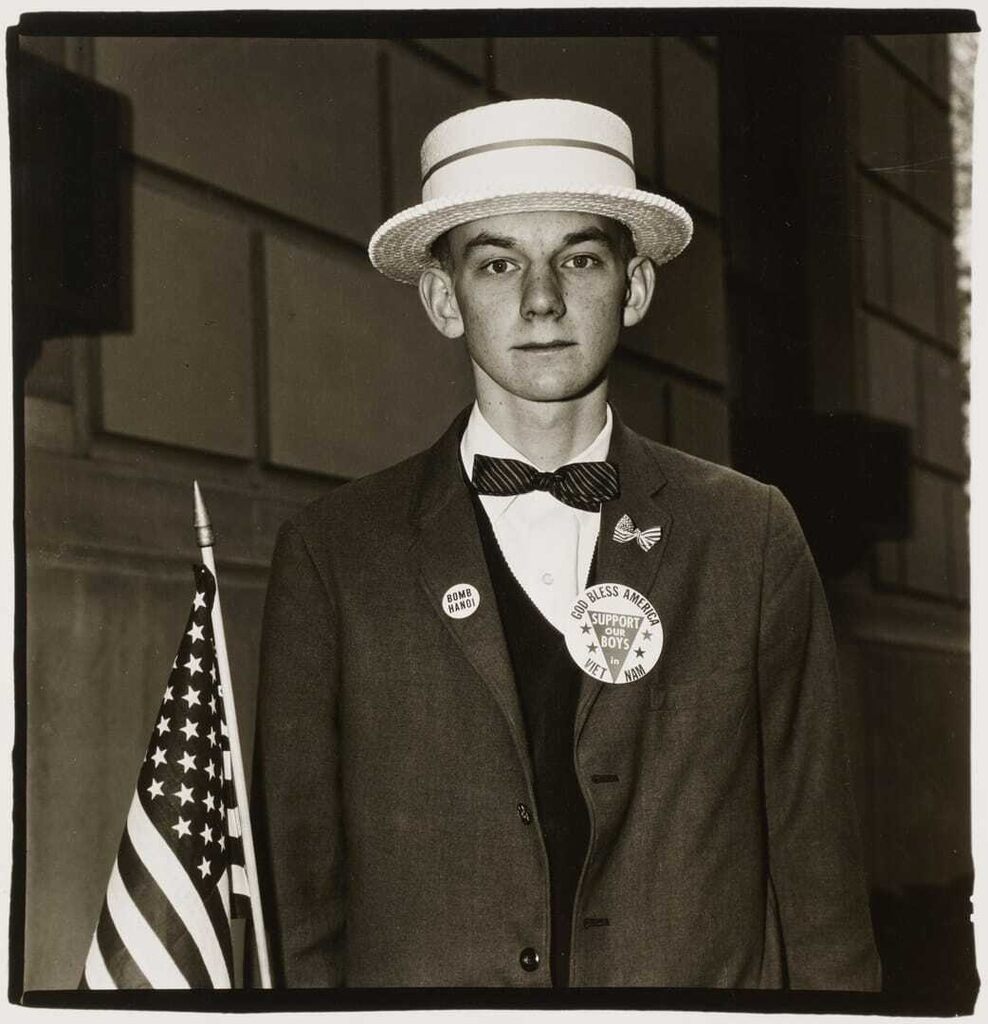 Boy with a straw hat waiting to march in a pro-war parade, NYC