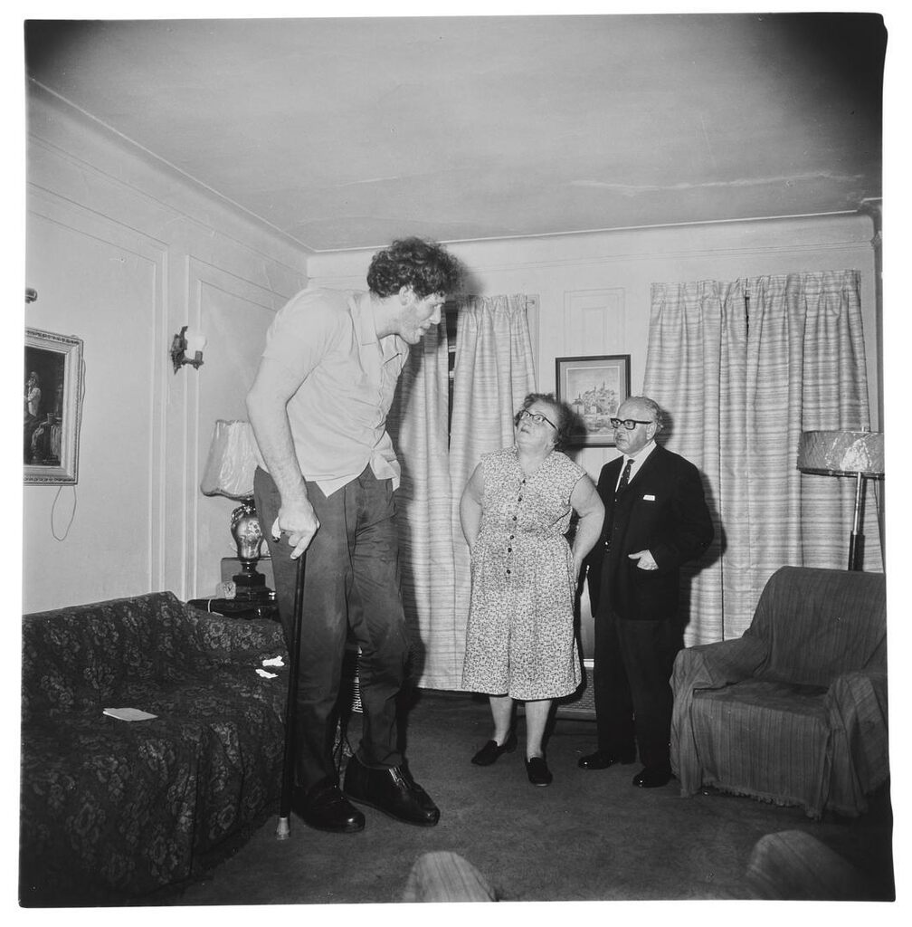 Diane Arbus, A Jewish giant at home with his parents in the Bronx, N.Y.