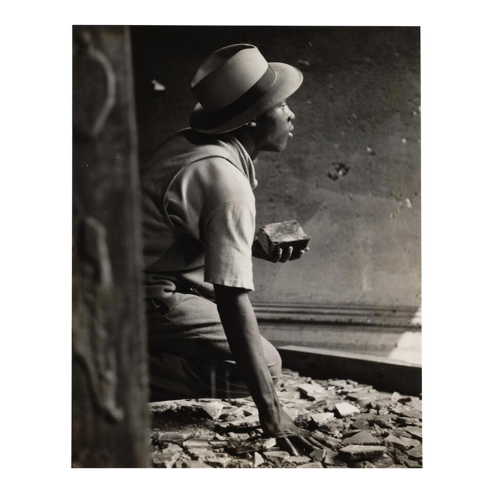 Nomad holds brick during siege in old house (from 'Harlem Gang Leader')