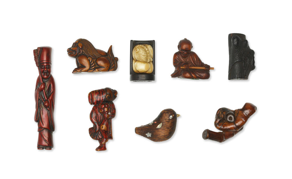 A group of eight wood and stag-antler netsuke
