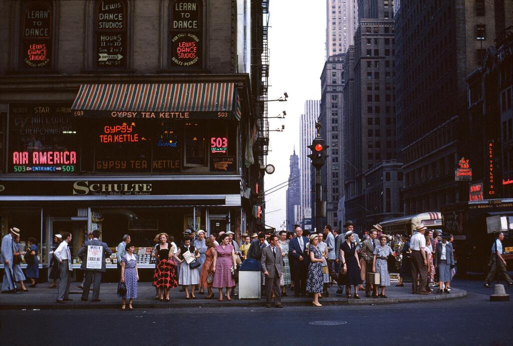 People waiting to cross Sixth Avenue, New York City