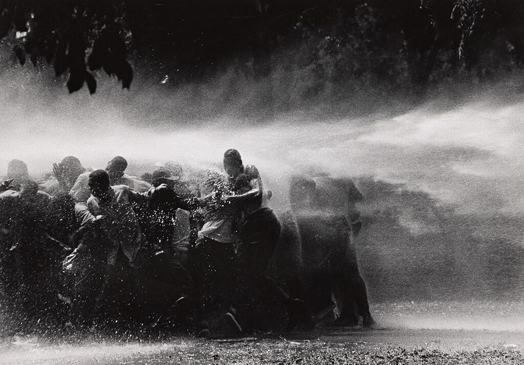 Civil rights demonstrators are sprayed with water in Birmingham, Alabama, 1963