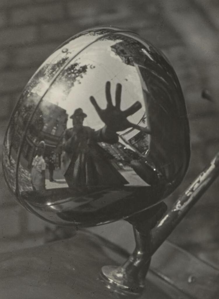 Self-Portrait in Reflection of Car Headlight
