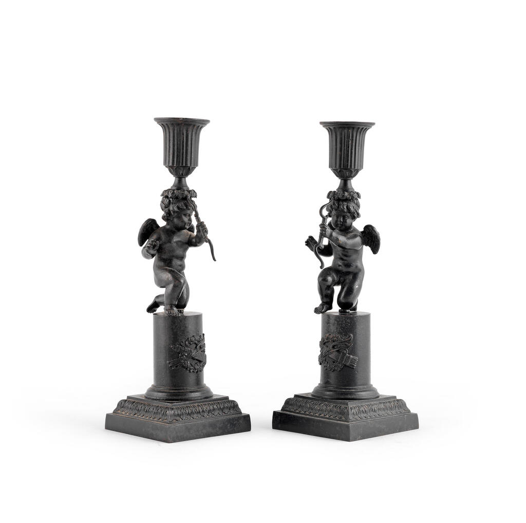 A pair of 19th century patinated iron candlesticks