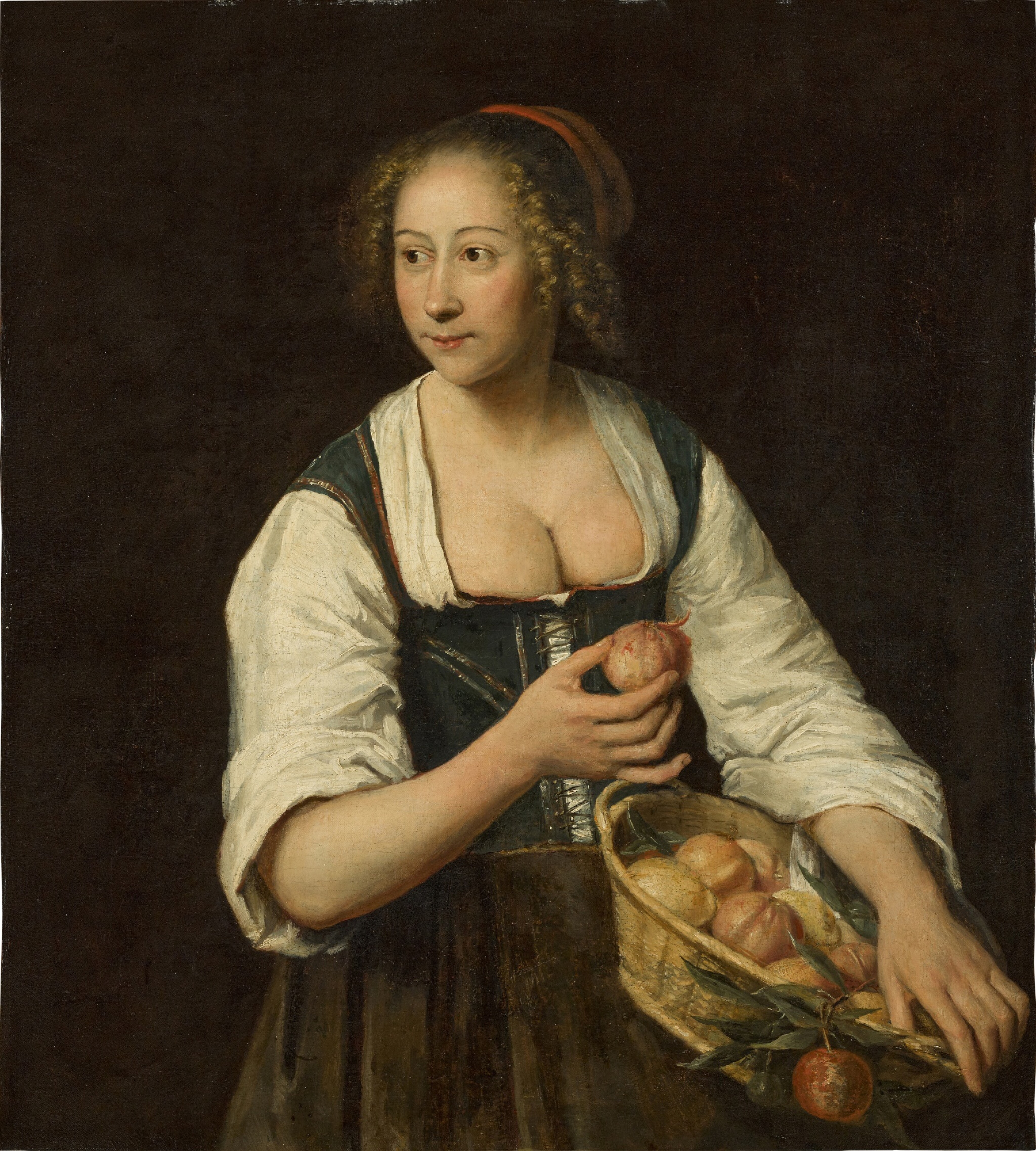 A young lady holding a fruit basket