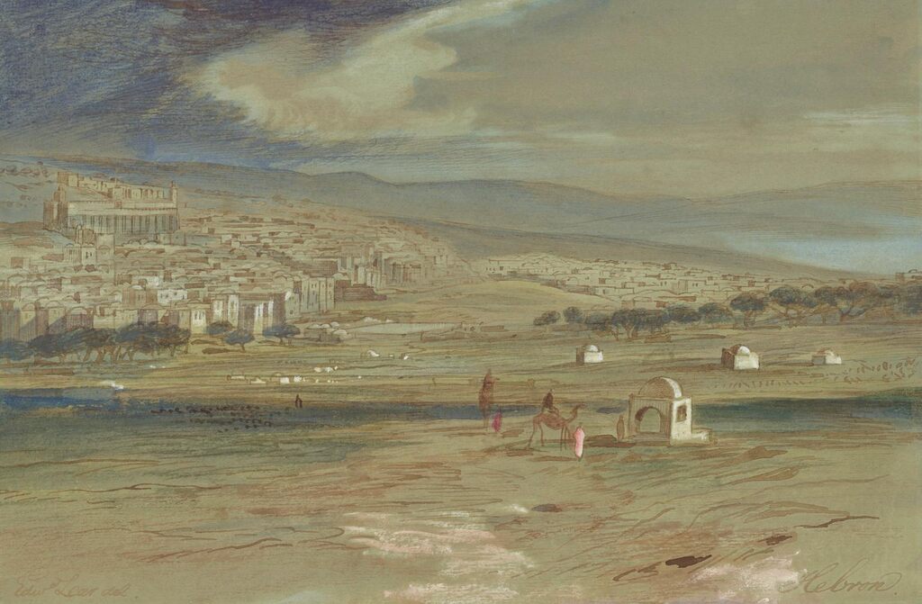 A view of the city of Hebron with camels and figures in the foreground