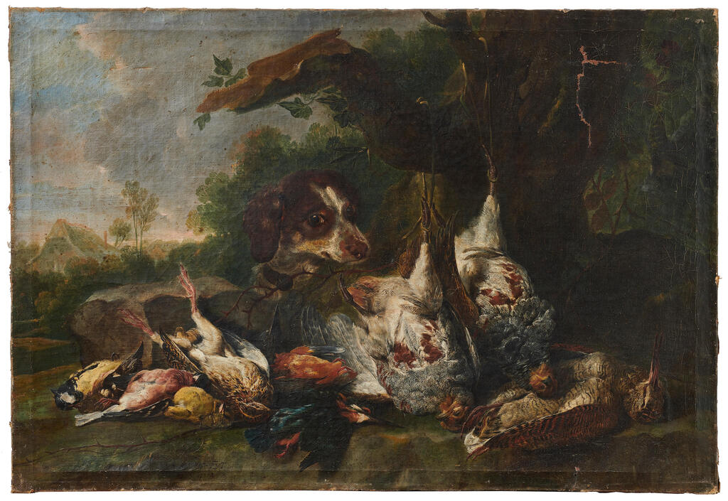 A hunting dog with dead birds at the foot of a tree