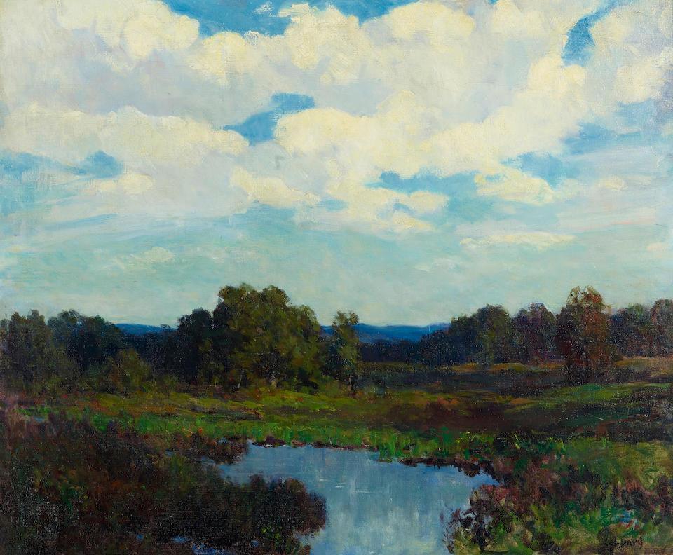 Billowy clouds above rolling hills
