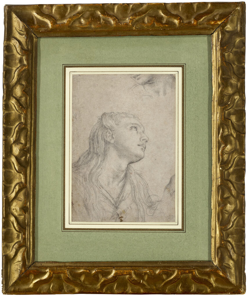 A head study of a young woman looking up, with a fragment of a second head study