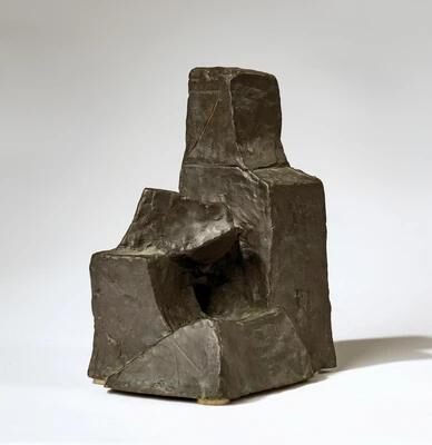 A small seated figure
