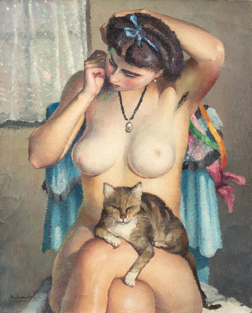 A nude woman seated with a cat