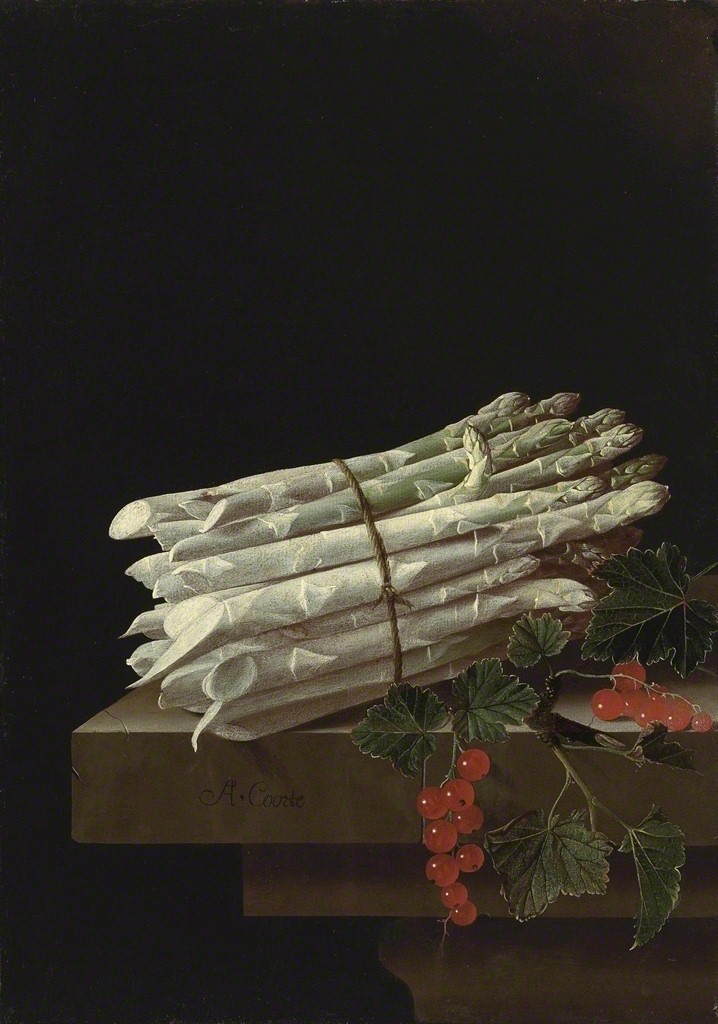 Asparagus and red currants on a stone ledge