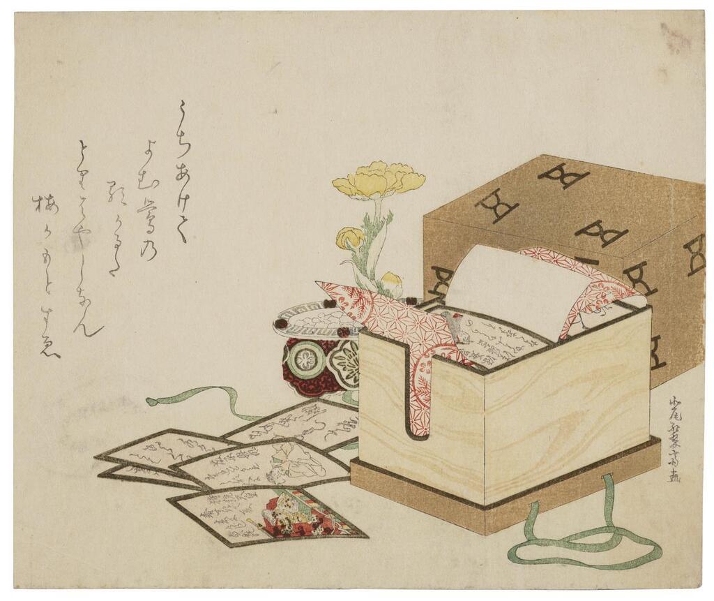 A box of hyakunin isshu poem cards and an adonis flower