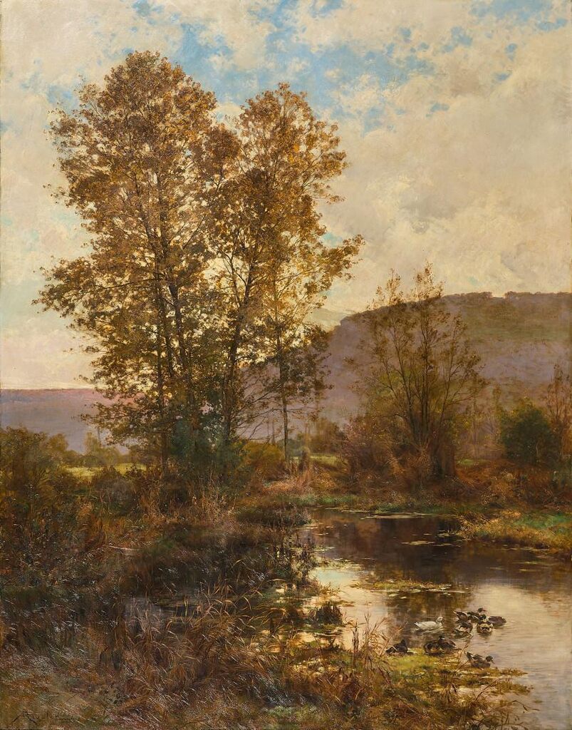 Ducks at the pond in an autumn landscape