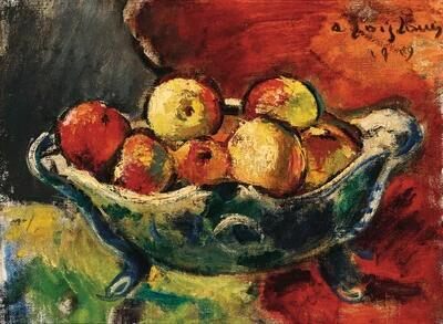 A silver bowl with apples