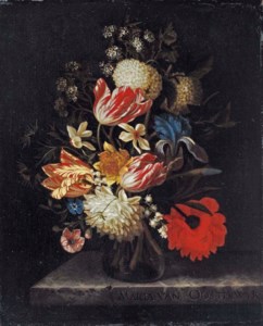 Tulips, lilies, roses, an iris and other flowers in a glass vase, on a marble ledge