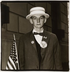 Boy with a straw hat waiting to march in a pro-war parade, NYC, 1967