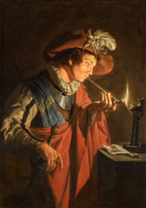 A young man lighting his pipe
