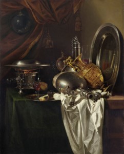 A chafing dish, two pilgrims' canteens, a silver-gilt ewer, a plate and other tableware on a partially draped table