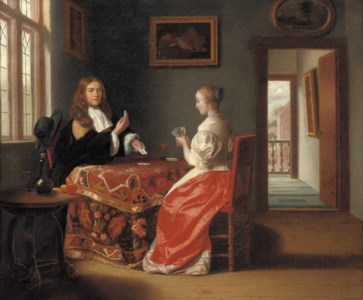 An elegant couple playing cards