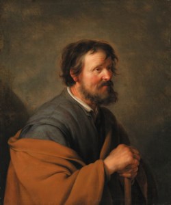 A seated man, his hand resting on a stick