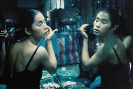 C. putting on her make-up at Second Tip, Bangkok, 1992