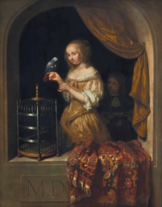 Woman feeding a parrot