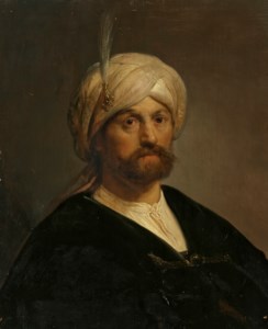 Head of a man, bust-length, wearing a turban and black cloak