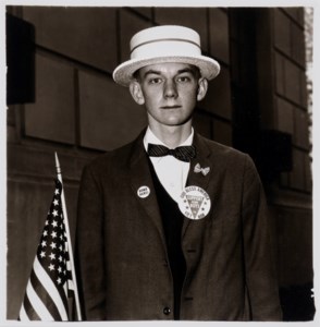 Boy with a straw hat waiting to march in a pro-war parade, NYC, 1967