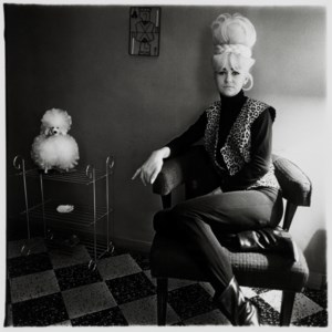 Lady bartender at home with a souvenir dog, New Orleans, LA., 1964