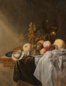 A bowl of peaches and grapes with a roemer and a peeled lemon, on a pewter plate, on a draped table