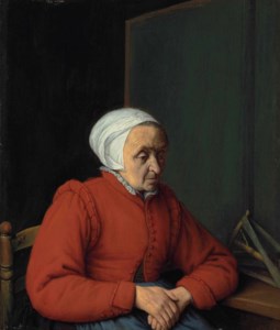 Portrait of an elderly lady in a red coat, seated by a table with a flax winder