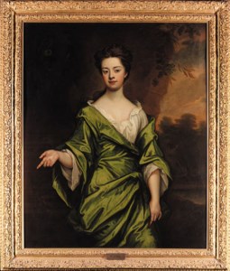 Portrait of Mrs Harris, three-quarter-length, in a green dress, seated in a wooded landscape