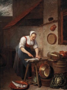 A maid standing by a table cleaning fish in a yard
