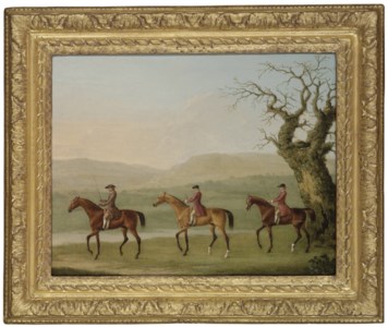 A trainer and two grooms exercising racehorses