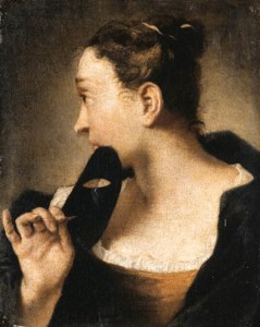 A Woman turning to the right holding a carnival Mask