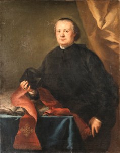 Portrait of a Prelate, three-quarter length, in a black cassock, holding a biretta, by a table in a draped interior