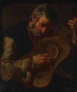 An old man playing the guitar