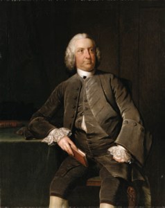 Portrait of a Gentleman, seated three-quarter length, in a grey velvet suit and lace cuffs, holding a book beside a table