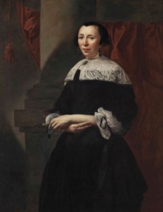 Portrait of a lady, three-quarter-length, in a black dress with white lace sleeves, a white lace collar and a black lace cap and wearing onyx earrings and necklace, holding a closed fan, standing before a column and a red curtain