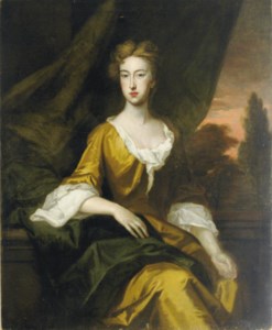 Portrait of a lady in a saffron dress, seated three-quarter length, in a landscape