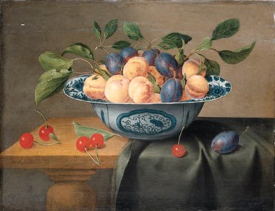 Plums and nectarines in a porcelain bowl with cherries on a partly draped table