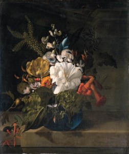 A white gentian, a cactus, a tulip and exotic flowers in a glass vase on a ledge