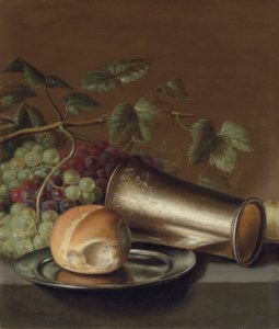 Bread on a pewter platter, an engraved silver cup, with grapes and a plum on a stone ledge
