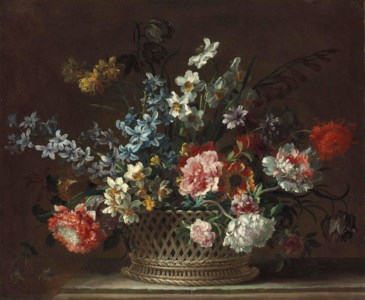Roses, daffodils, hyacinths, anemones, fritillaries and other flowers in a woven basket on a stone ledge