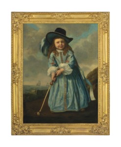 Portrait of a boy playing golf by the shore