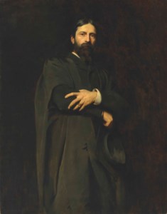 Sir Hubert von Herkomer, R.A., three-quarter-length, standing, wearing the Slade Professor's gown and holding a mortar-board